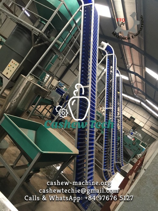 Inclined conveyor lifting raw cashew nut (RCN) bags from the yard into the factory intake